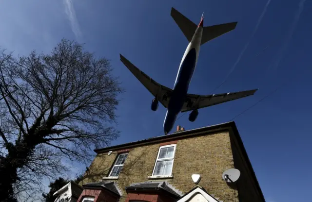 Plane flying over house