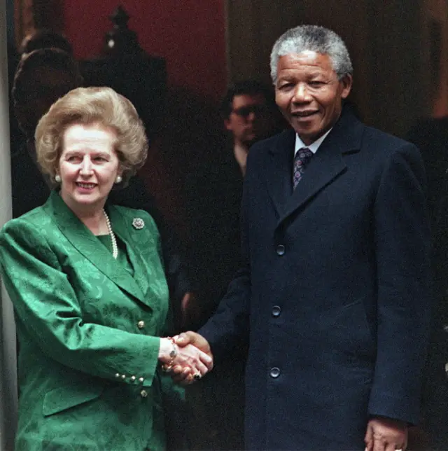 outh African anti-apartheid leader and African National Congress (ANC) member Nelson Mandela (R) shakes hands with British Prime Minister Margaret Thatcher 04 July 1990 on the steps of No 10 Downing Street.