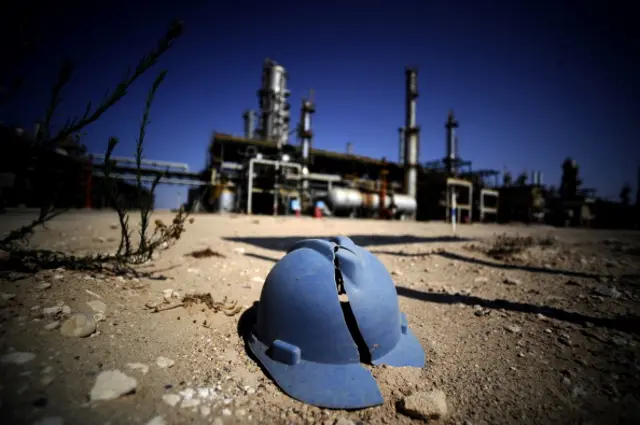 A worker's helmet lies on the ground at the Zawiya oil refinery, some 40 kms west of Tripoli, on August 19, 2011