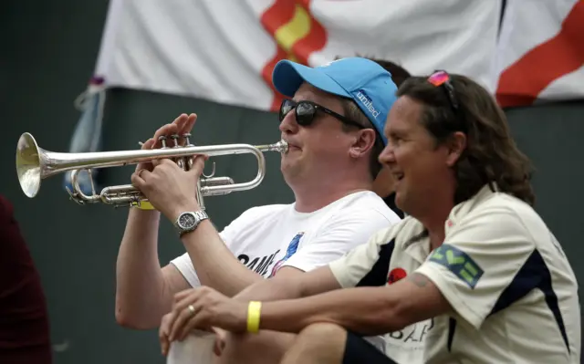 An England fan plays the trumpet