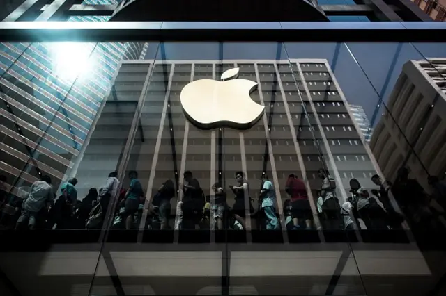 Customers queue inside an Apple store in Hong Kong