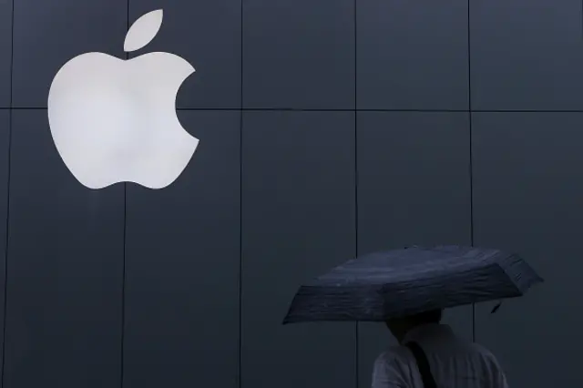 The Apple logo is seen on the wall at Apple Ginza store