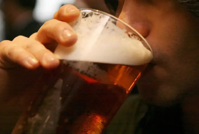 Man drinking pint