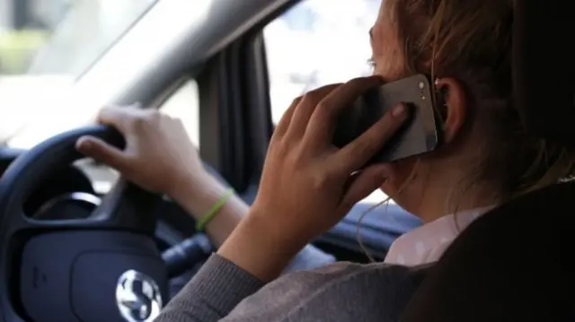 person on the phone in a car