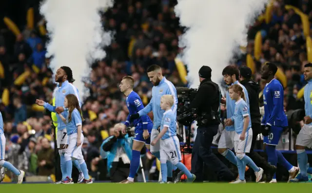 Teams enter the pitch