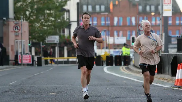 David Cameron jogging with MP Desmond Swayne in Manchester