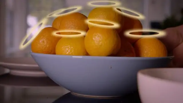 oranges in a bowl with halos