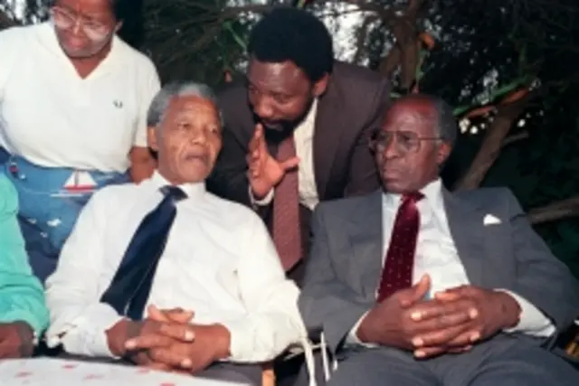 Nelson Mandela (L) and Andrew Mlangeni (R) listen to Cyril Ramaphosa in Soweto