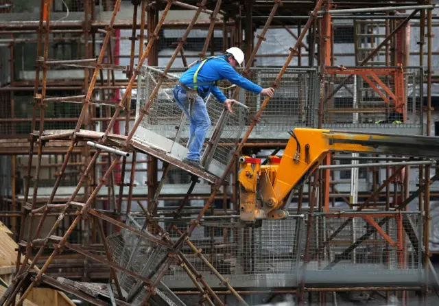 Riggers remove scaffolding from a house building site at Lenzie after it fell down overnight, as winds of more than 90mph have hit the west of Scotland as Storm Gertrude sweeps the country.