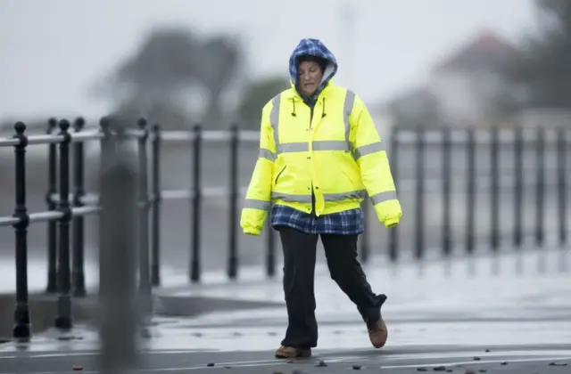 A woman walks along the sea front in Largs