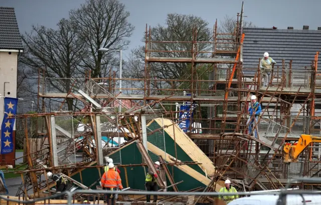 Riggers remove scaffolding from a house building site at Lenzie after it fell down overnight, as winds of more than 90mph have hit the west of Scotland as Storm Gertrude sweeps the country,