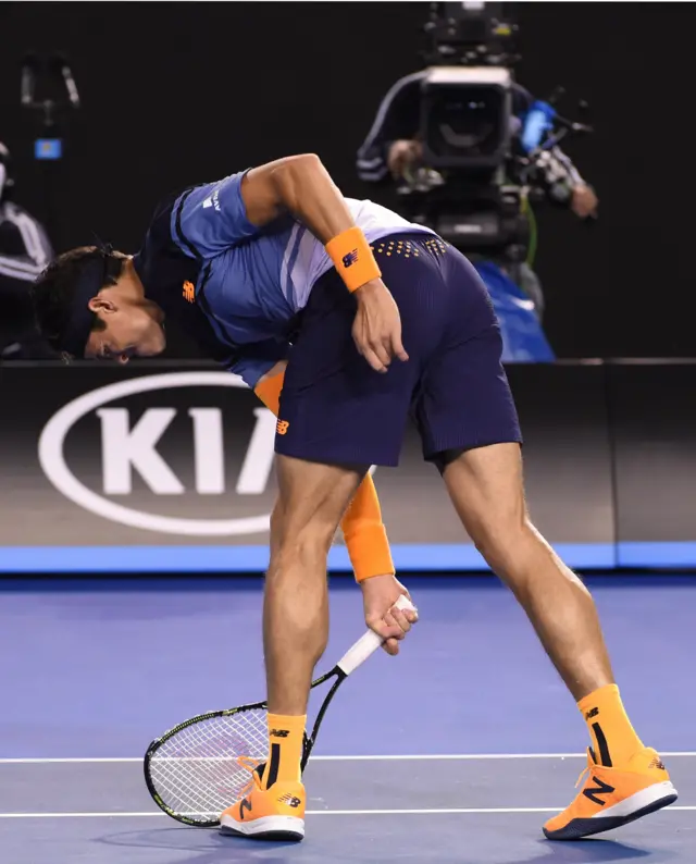 Milos Raonic smashes his racquet