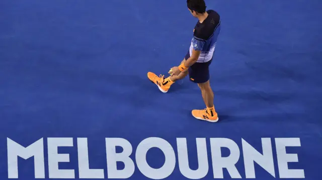 Milos Raonic walks on court