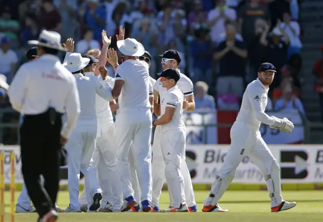 England celebrate after Stokes takes a wicket