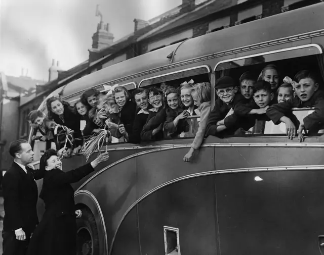 Children pile into a bus