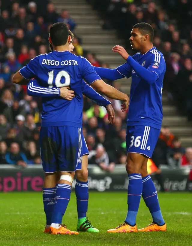 Oscar of Chelsea celebrates scoring the opening goal with Diego Costa and Ruben Loftus-Cheek of Chelsea during the Emirates FA Cup Fourth Round match between Milton Keynes Dons and Chelsea at Stadium mk