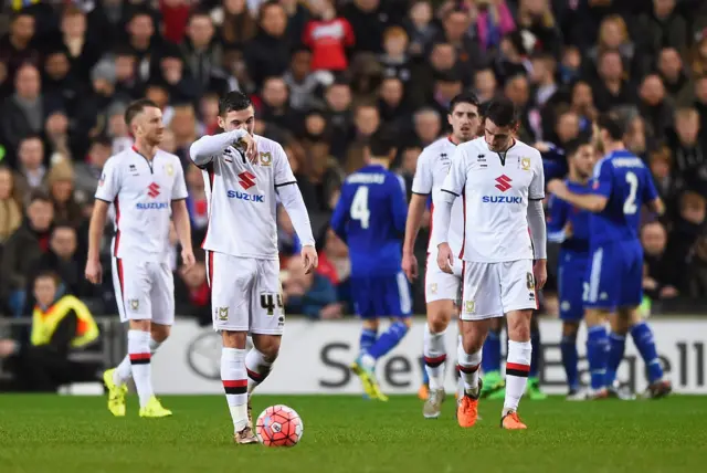 Jake Forster-Caskey (L) of MK Dons looks dejected after Chelsea"s second goal during the Emirates FA Cup Fourth Round match between Milton Keynes Dons and Chelsea at Stadium mk