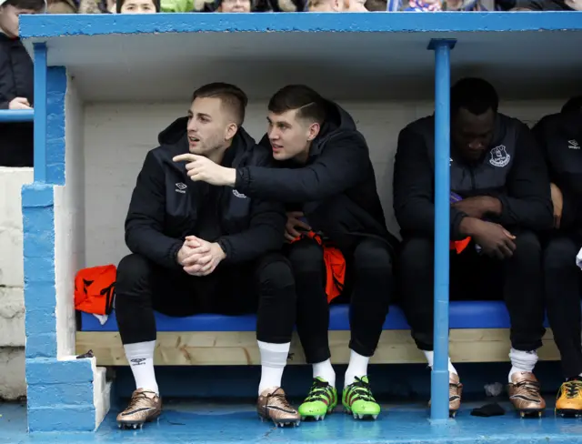 Everton"s Gerard Deulofeu, John Stones and Romelu Lukaku on the substitutes bench