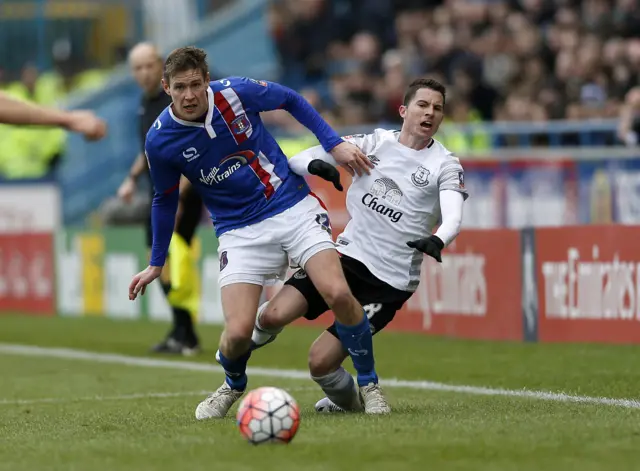 Carlisle United"s Antony Sweeney and Everton"s Bryan Oviedo (right) battle for the ball during the Emirates FA Cup, fourth round match at Brunton Park