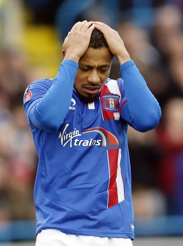 Carlisle United"s Derek Asamoah looks dejected