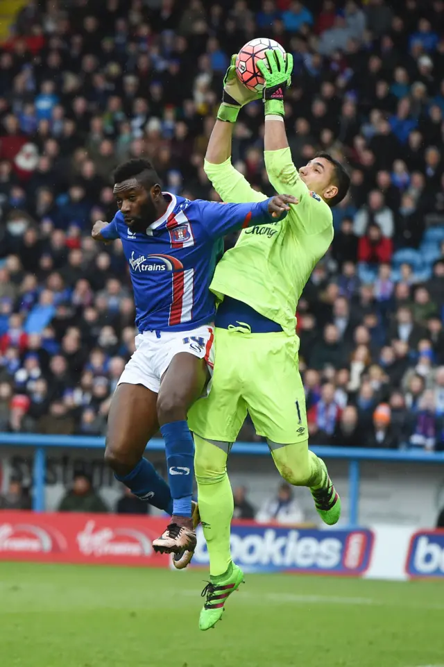 Everton"s Spanish goalkeeper Joel Robles (R) claims the ball from Carlisle United"s English striker Jabo Ibehre (L) during the English FA Cup fourth round football match between Carlisle United and Everton at Brunton Park