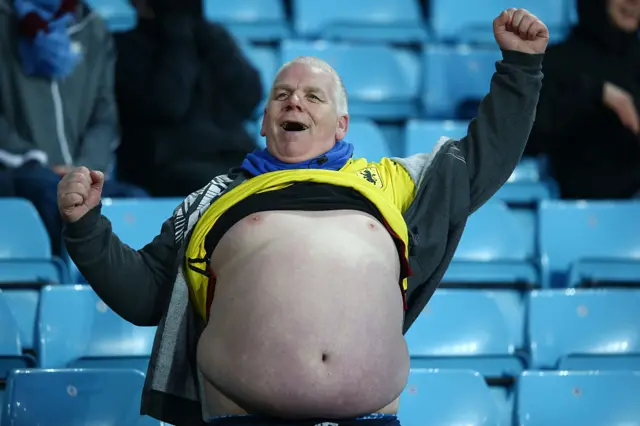 An Aston Villa fan with his belly out