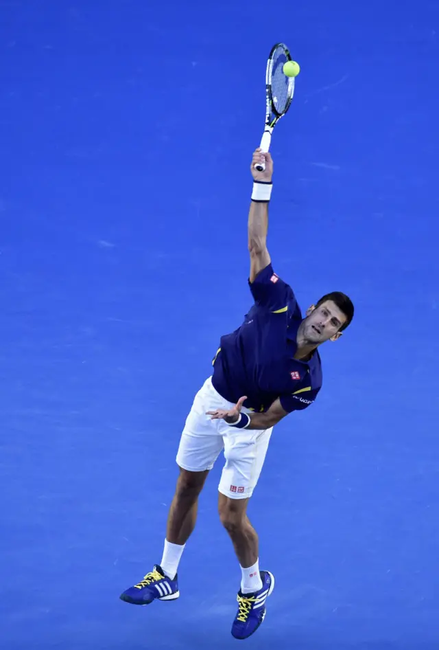 Novak Djokovic serves