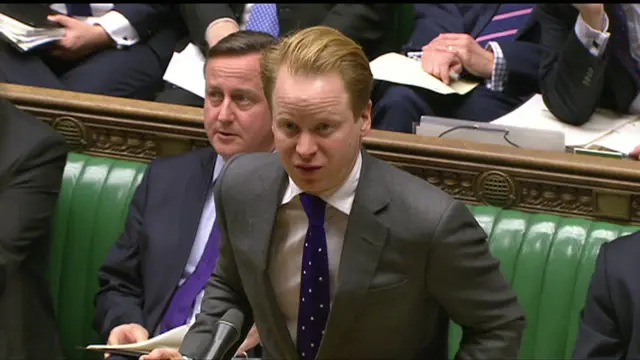 David Cameron sitting behind health minister Ben Gummer