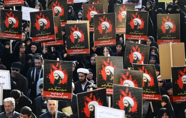 Iranians hold posters of Shiite cleric Nimr al-Nimr during an anti-Saudi Arabia demonstration at the Imam Hossein square in Tehran