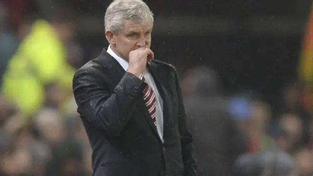 Mark Hughes looks on