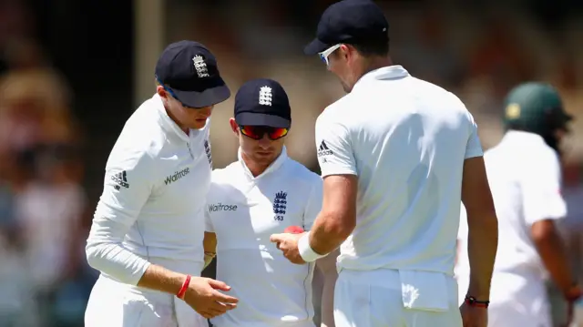 Joe Root, Jame Taylor and James Anderson inspect the ball