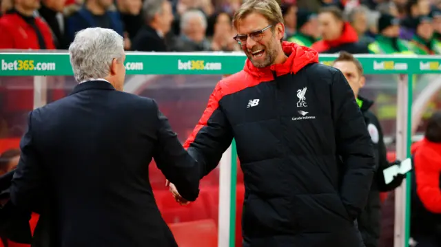 uergen Klopp shakes hands with Stoke manager Mark Hughes