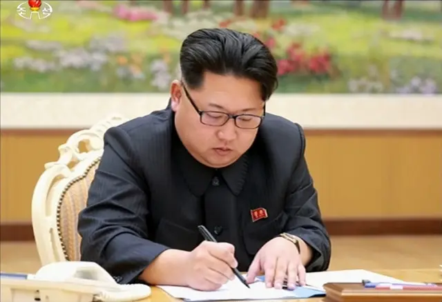 This picture taken from North Korean TV and released by South Korean news agency Yonhap shows North Korean leader Kim Jong-un signing a document authorising a hydrogen bomb test in Pyongyang on Wednesday 6 January 2016