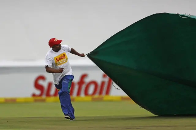 Covers are brought onto the pitch