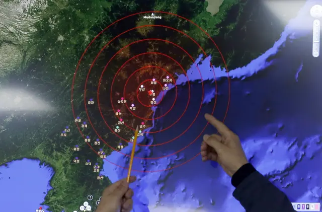 Officers from the Korea Meteorological Administration point at the epicentre of seismic waves in North Korea, at the National Earthquake and Volcano Center of the Korea Meteorological Administration in Seoul, South Korea, Wednesday, 6 January 2016.