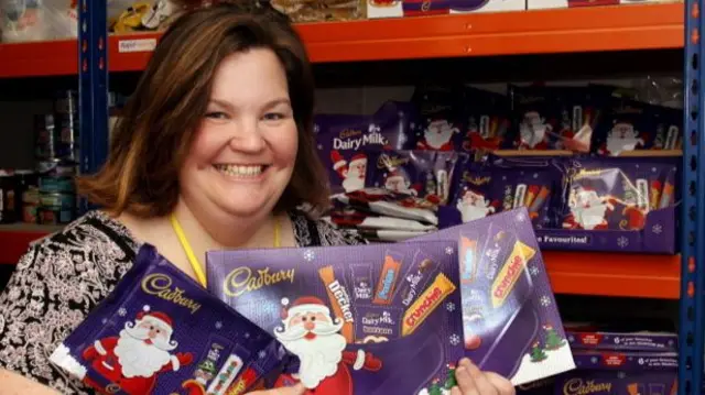 Cathy Mailins is pictured with some of the chocolate boxes