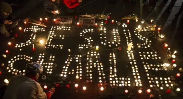 Candles are lit in rememberence of those killed in the Charlie Hebdo attacks