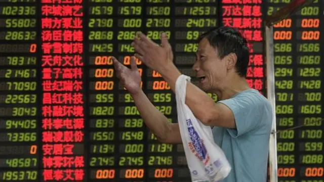 Man in front of China stock exchange board