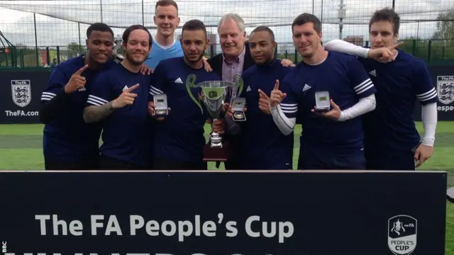 Prizehunters lift the 2015 adult men's trophy from the FA People's Cup with FA Cup winner Joe Royle