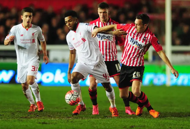 Jerome Sinclair of Liverpool holds off Jordan Tillson of Exeter City