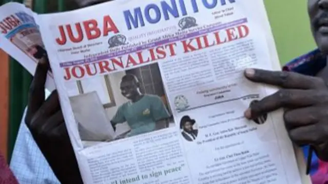 A man reads a copy of the Juba Monitor newspaper