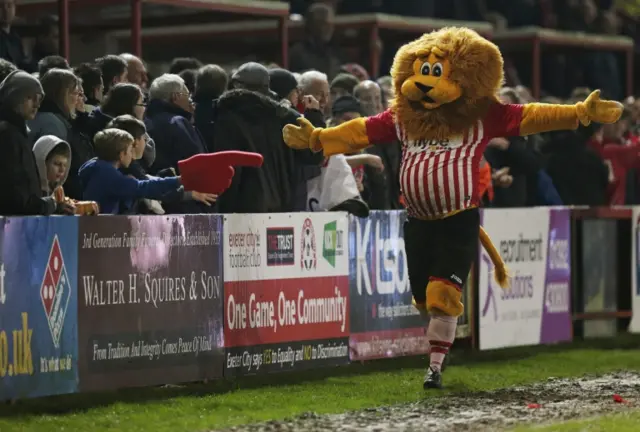 Exeter City's mascot celebrates with the fans