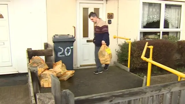 Man taking recycling outside