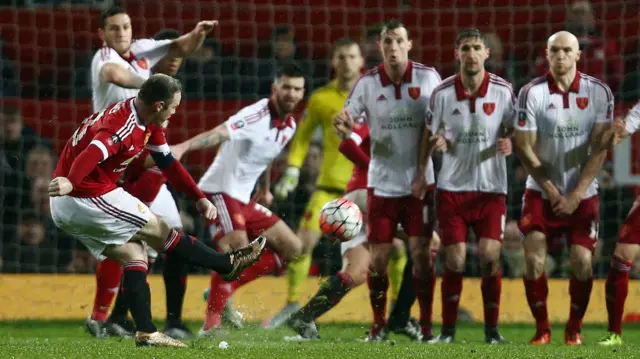 Wayne Rooney takes a free kick