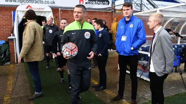 Referee Iain Williamson walks out to inspect the pitch