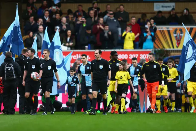 Wycombe and Aston Villa enter the pitch