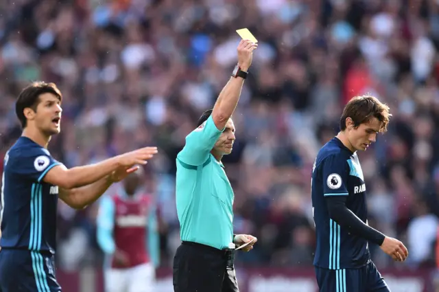 Marten de Roon is shown a yellow card