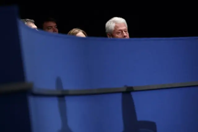 Former president Bill Clinton waits for the start of the second presidential debate