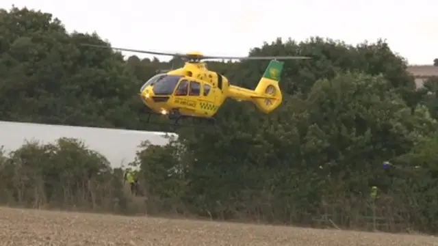 A helicopter landing at the crash site