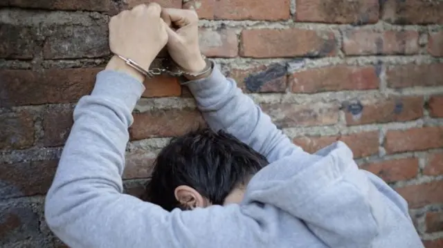 Picture of youth in handcuffs